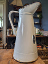 White enamel pitcher with navy blue rim