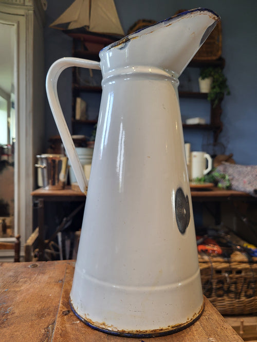 White enamel pitcher with navy blue rim